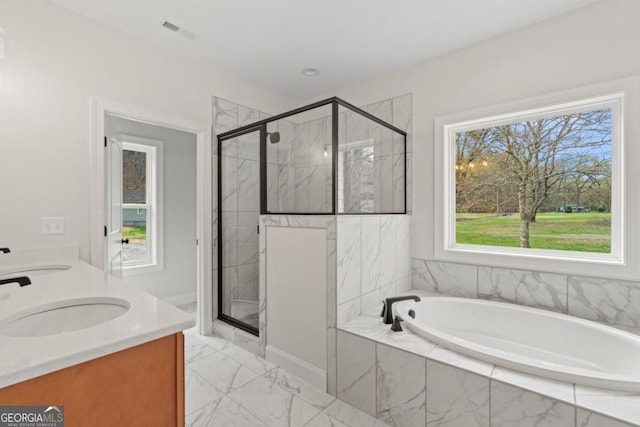 bathroom with a garden tub, visible vents, marble finish floor, a sink, and a stall shower