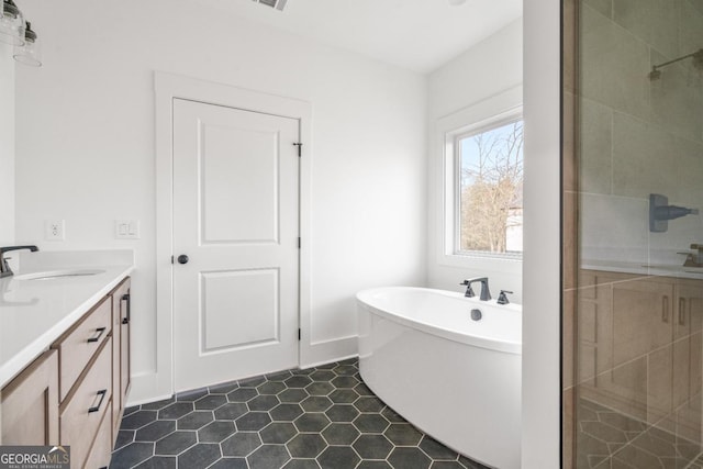 full bathroom with a stall shower, visible vents, vanity, and a freestanding bath
