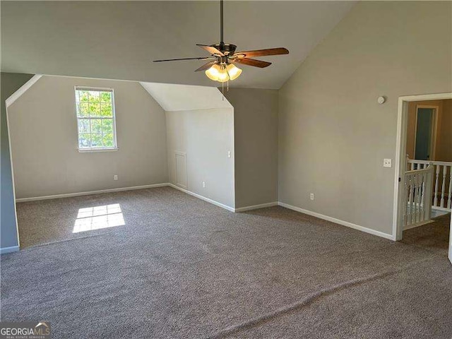 additional living space featuring carpet, a ceiling fan, vaulted ceiling, and baseboards