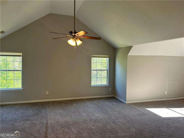interior space with lofted ceiling, carpet, ceiling fan, and baseboards