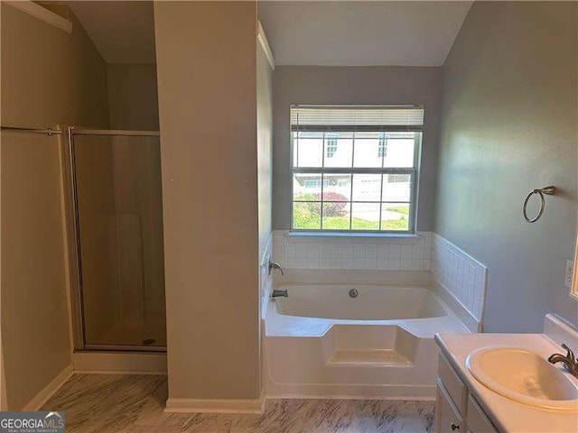 full bath featuring baseboards, a stall shower, a garden tub, and vanity