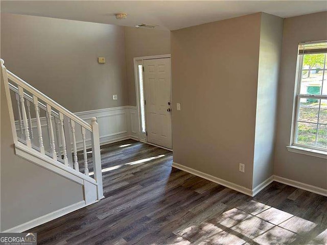 entrance foyer with wood finished floors, plenty of natural light, and stairs
