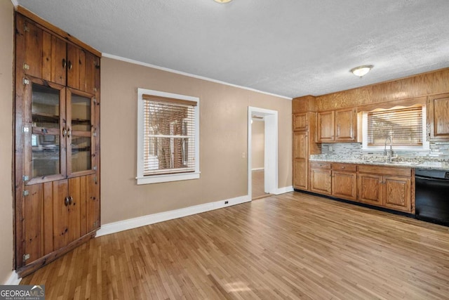 340 Lavista Dr, Blue Ridge, GA 30513 - kitchen featuring baseboards, black dishwasher, a sink, backsplash, and light wood-style flooring