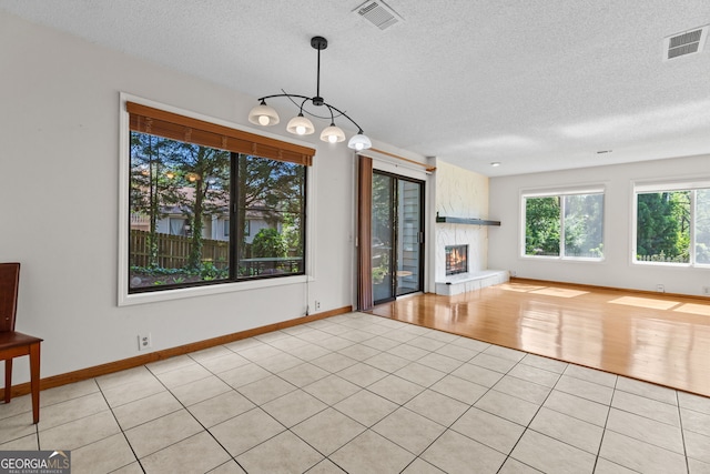 890 Muirfield Rdg, Marietta, GA 30068 - unfurnished living room with a textured ceiling, light tile patterned flooring, baseboards, and visible vents