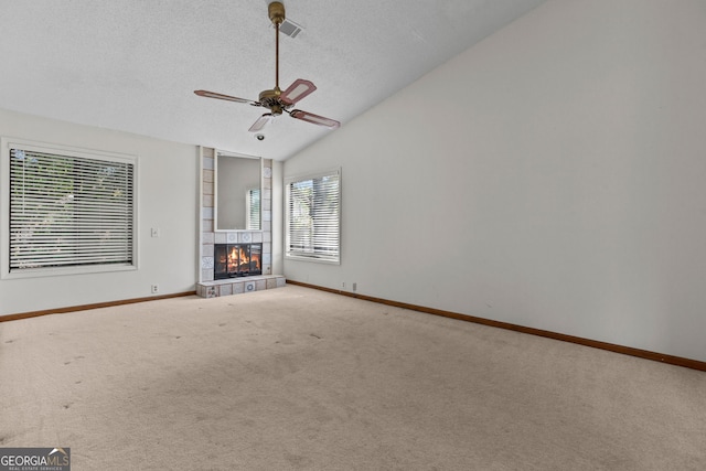 890 Muirfield Rdg, Marietta, GA 30068 - unfurnished living room with ceiling fan, carpet, a textured ceiling, a fireplace, and vaulted ceiling