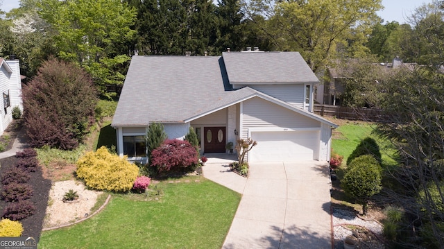890 Muirfield Rdg, Marietta, GA 30068 - view of front of home with a garage, a front yard, fence, a shingled roof, and concrete driveway