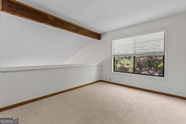 890 Muirfield Rdg, Marietta, GA 30068 - carpeted spare room with baseboards, vaulted ceiling with beams, and a textured ceiling