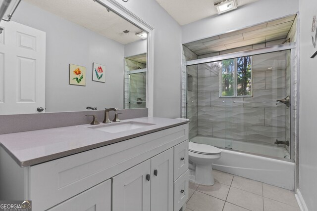 890 Muirfield Rdg, Marietta, GA 30068 - bathroom with tile patterned flooring, vanity, toilet, and bath / shower combo with glass door