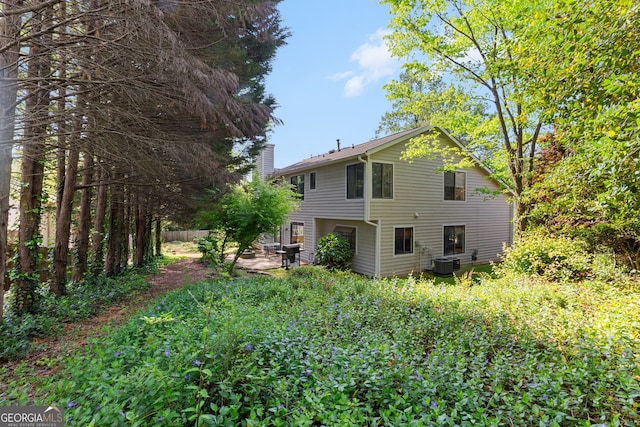 890 Muirfield Rdg, Marietta, GA 30068 - back of property with a chimney and central AC unit