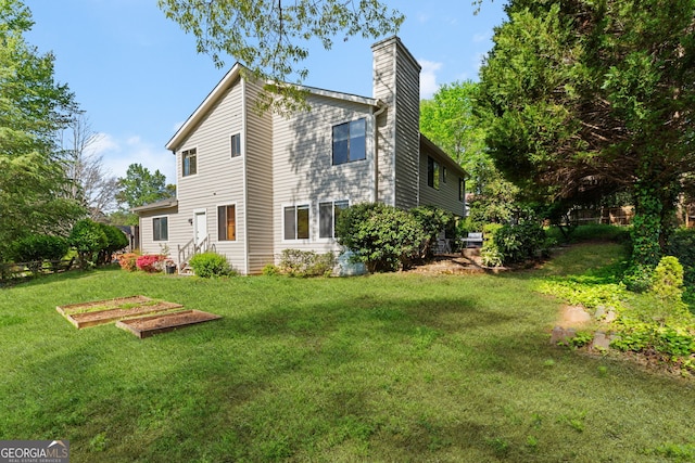 890 Muirfield Rdg, Marietta, GA 30068 - back of house featuring entry steps, a yard, and a chimney