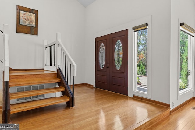 890 Muirfield Rdg, Marietta, GA 30068 - foyer entrance featuring baseboards, stairs, wood finished floors, and a healthy amount of sunlight