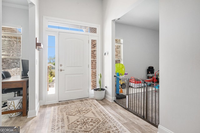 entryway with baseboards and wood finished floors