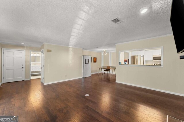 208 Bainbridge Dr, Atlanta, GA 30327 - unfurnished living room featuring wood finished floors, baseboards, visible vents, and a notable chandelier