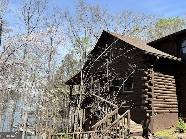 view of side of home with log siding