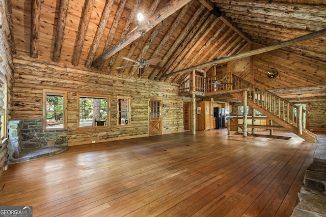 unfurnished living room featuring high vaulted ceiling, beamed ceiling, hardwood / wood-style floors, and ceiling fan