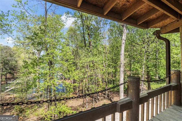 wooden deck with a wooded view