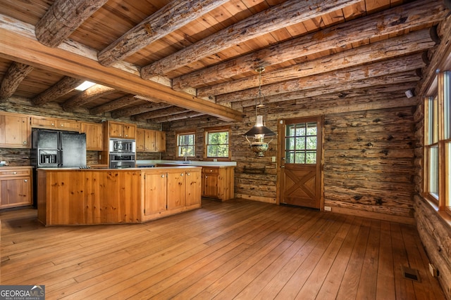 kitchen with a kitchen island, visible vents, stainless steel appliances, wood-type flooring, and wooden ceiling