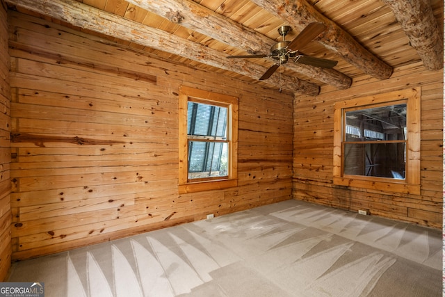 unfurnished room featuring wooden walls, beamed ceiling, carpet, and wood ceiling