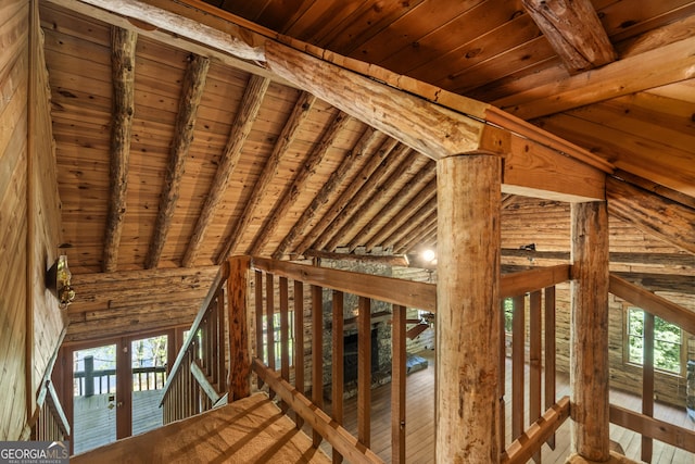 interior space featuring beam ceiling, wooden ceiling, and plenty of natural light