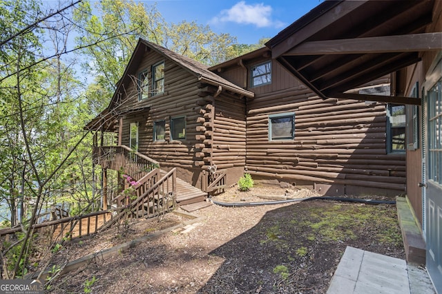 view of property exterior with log siding