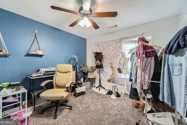 office with visible vents, ceiling fan, and carpet floors