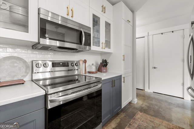 245 N Highland Ave NE Unit 220, Atlanta, GA 30307 - kitchen with stainless steel appliances, gray cabinetry, light countertops, and glass insert cabinets