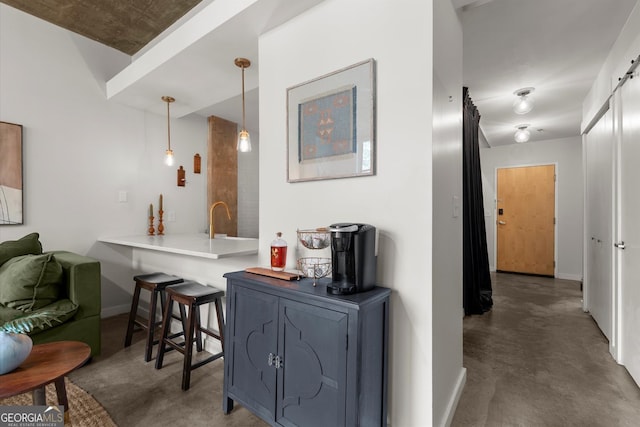 245 N Highland Ave NE Unit 220, Atlanta, GA 30307 - hallway with finished concrete flooring, baseboards, a sink, and a barn door