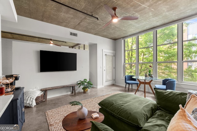 245 N Highland Ave NE Unit 220, Atlanta, GA 30307 - living area featuring ceiling fan, healthy amount of natural light, concrete floors, and baseboards