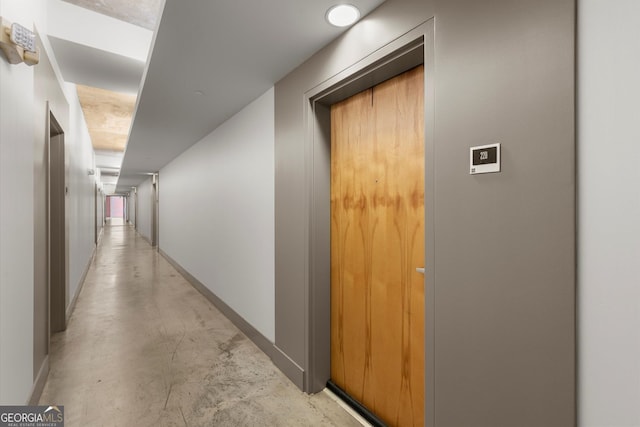 245 N Highland Ave NE Unit 220, Atlanta, GA 30307 - hallway with concrete flooring, baseboards, and elevator