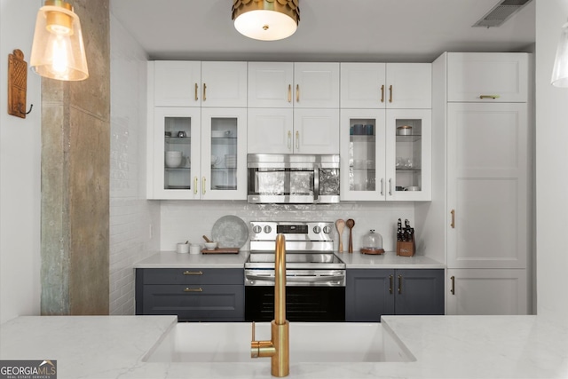 245 N Highland Ave NE Unit 220, Atlanta, GA 30307 - bar area featuring appliances with stainless steel finishes and backsplash