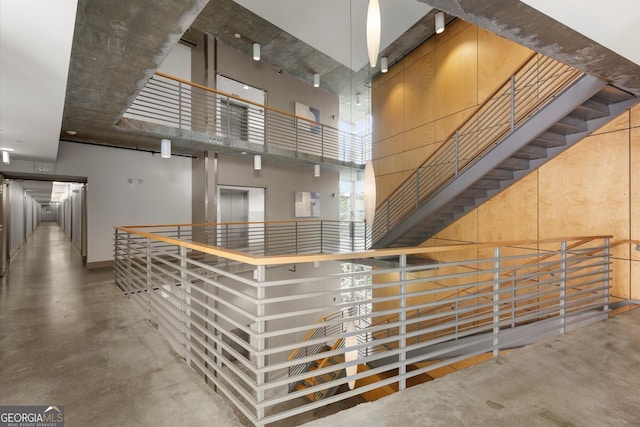 245 N Highland Ave NE Unit 220, Atlanta, GA 30307 - interior space featuring a high ceiling, finished concrete flooring, baseboards, and elevator