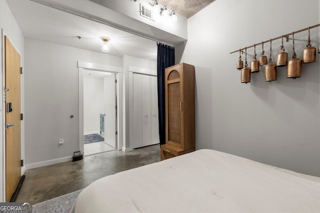 245 N Highland Ave NE Unit 220, Atlanta, GA 30307 - bedroom with concrete floors, baseboards, and a closet