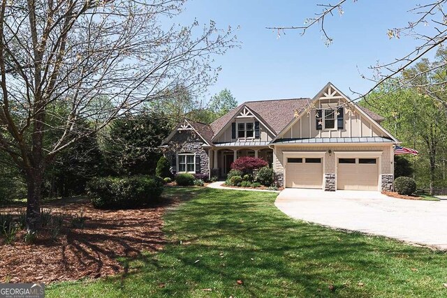5095 Hamby Hollow Ln, Cumming, GA 30028 - craftsman inspired home featuring board and batten siding, a garage, a front yard, stone siding, and concrete driveway