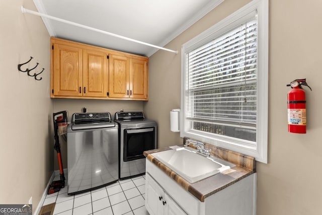 laundry room with independent washer and dryer, cabinet space, healthy amount of natural light, ornamental molding, and light tile patterned flooring
