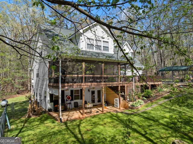 back of property with a sunroom, a patio area, french doors, a deck, and roof with shingles