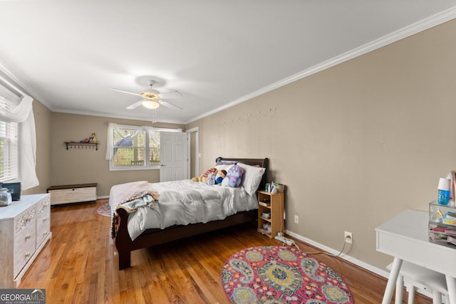 bedroom featuring ornamental molding, light wood-style flooring, ceiling fan, and baseboards