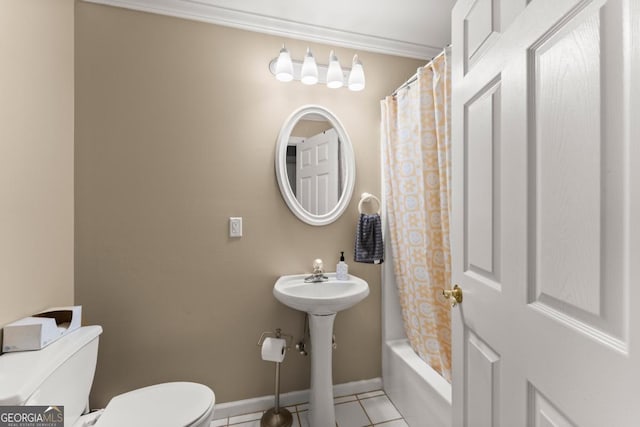 bathroom with toilet, baseboards, tile patterned floors, and ornamental molding