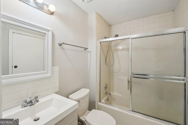 full bathroom with toilet, enclosed tub / shower combo, a textured ceiling, vanity, and decorative backsplash
