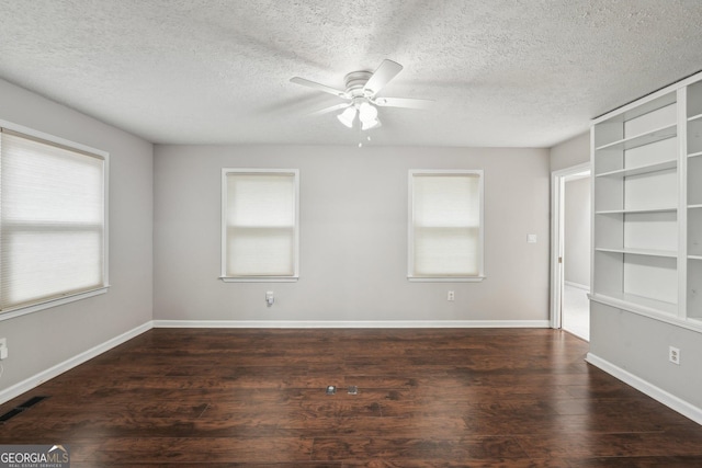 unfurnished room featuring a textured ceiling, a ceiling fan, visible vents, wood finished floors, and baseboards