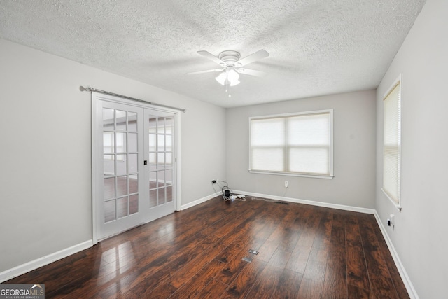 spare room featuring ceiling fan, a textured ceiling, french doors, wood-type flooring, and baseboards