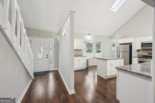 entrance foyer with high vaulted ceiling, baseboards, and dark wood-style floors