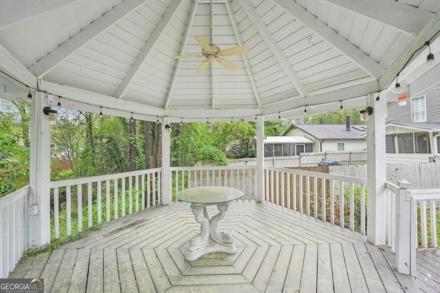 wooden terrace with a gazebo and fence