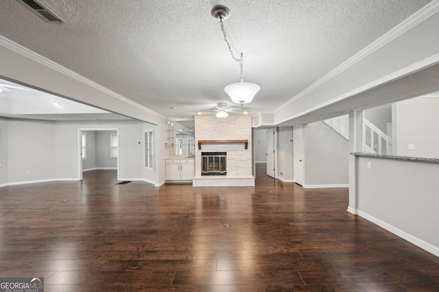 unfurnished living room featuring crown molding, baseboards, and a ceiling fan