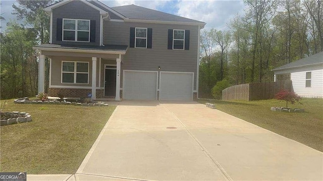 184 Grafton St, Hampton, GA 30228 - view of front of property featuring an attached garage, concrete driveway, a front yard, and brick siding