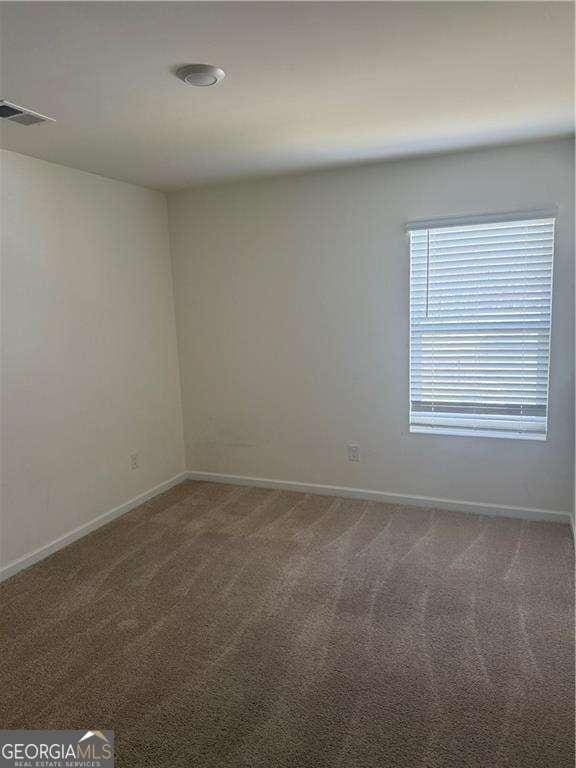 184 Grafton St, Hampton, GA 30228 - unfurnished room featuring visible vents, baseboards, and carpet flooring