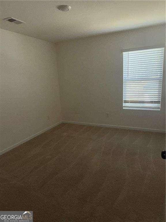 184 Grafton St, Hampton, GA 30228 - empty room featuring visible vents, baseboards, and carpet