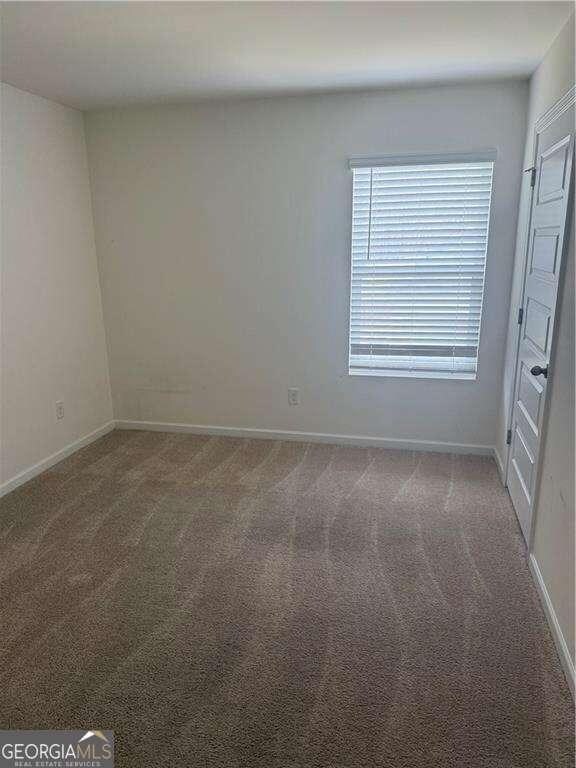 184 Grafton St, Hampton, GA 30228 - spare room featuring baseboards and carpet