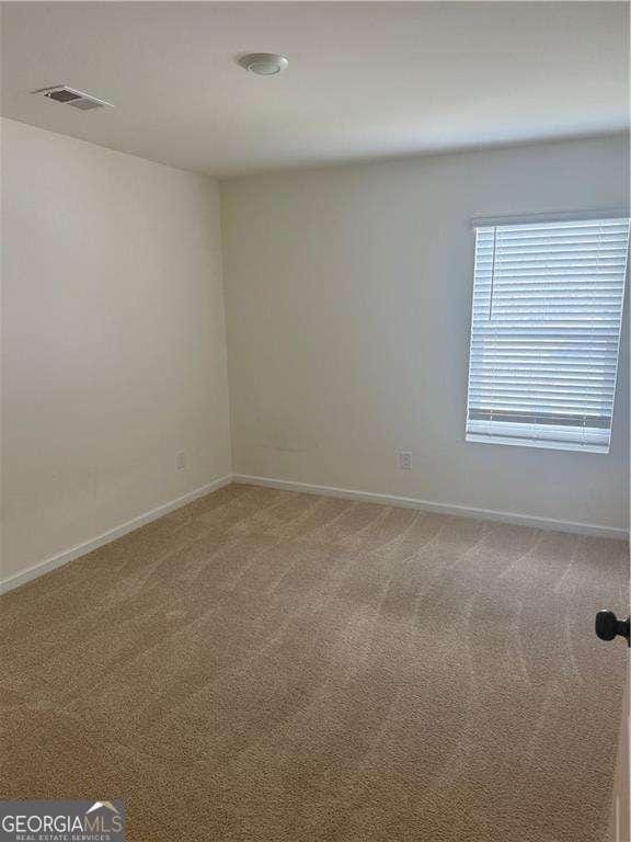 184 Grafton St, Hampton, GA 30228 - spare room with light carpet, visible vents, and baseboards