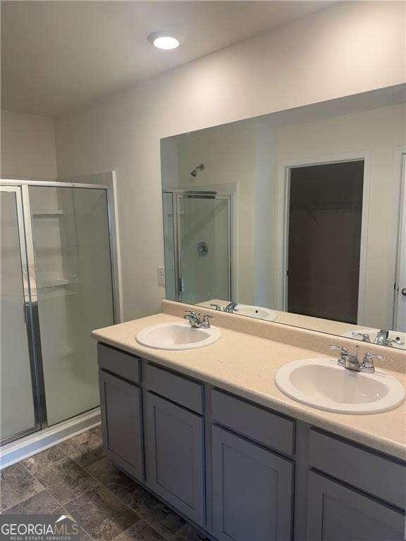 184 Grafton St, Hampton, GA 30228 - full bath featuring a shower stall, double vanity, a sink, and a spacious closet