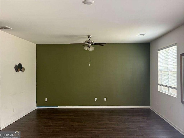 184 Grafton St, Hampton, GA 30228 - spare room featuring visible vents, dark wood-style flooring, baseboards, and ceiling fan